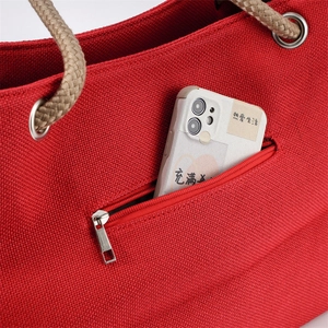 Red canvas tote bag with hemp rope handles and front zipper pocket for daily commute