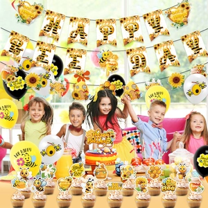 Bee theme birthday party supplies with banner balloons and cake toppers for kids