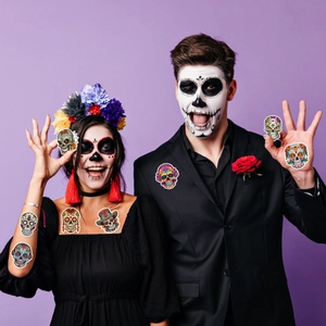 Detailed view of colorful Day of the Dead sugar skull temporary tattoos on face and skin