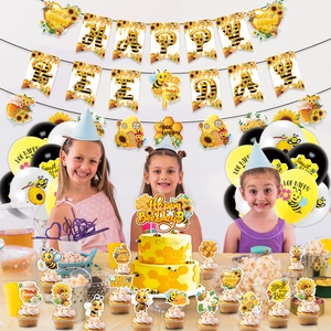 Detailed view of bee-themed birthday party decorations with banners and cake toppers