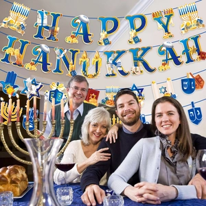 Blue and gold Happy Hanukkah banner hanging over a family gathering for Jewish party decor
