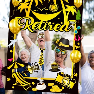 Outdoor retirement party scene with elderly people using yellow and black photo booth props