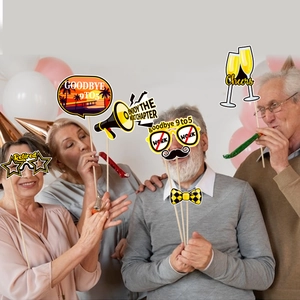 Seniors celebrating with fun retirement party photo booth props and colorful balloons