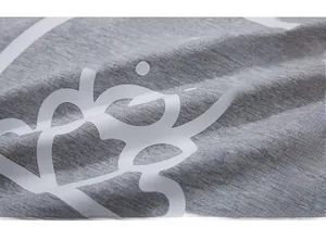 Detailed macro view of gray knitted fabric texture with white bear and pink text print