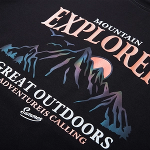 Oversized black T-shirt featuring a mountain explorer graphic with gradient sunset design