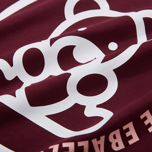 Oversize burgundy cotton T-shirt featuring a stylized bear print and pink typography