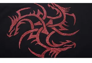 Detailed close-up of sparkling red dragon print on black fabric with metallic glitter