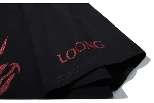 Detail of glittery red LOONG print on black cotton sleeve for oversized streetwear T-shirt
