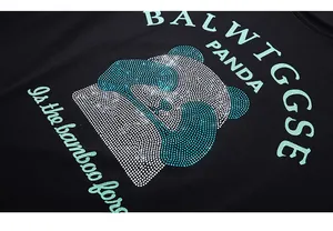Detail of panda pattern with mint green rhinestones on black cotton oversized T-shirt