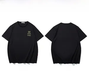 Detail view of black oversized T-shirt with golden bear embroidery and XFPARRE logo