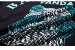 Detail of rhinestone panda head and B PANDA glitter typography on black t-shirt fabric