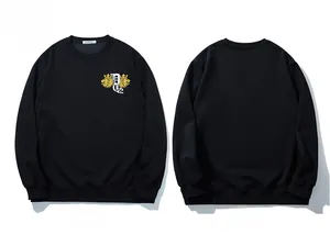 Detail of black crewneck sweatshirt featuring golden lion and crown embroidery on chest