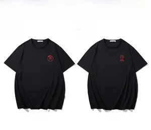 Flat lay of two black cotton t-shirts featuring red dragon embroidery and round necklines