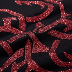 Macro shot of oversized black T-shirt featuring a glittery red dragon totem graphic