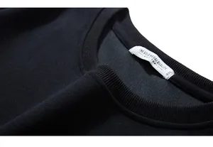 Detailed view of ribbed crew neck and 4XL size label on black cotton sweatshirt