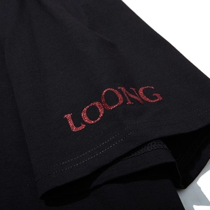 Close-up of black oversized T-shirt with red glitter LOONG print on the short sleeve
