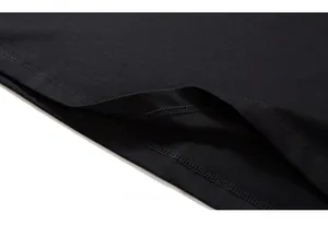 Close-up of double-needle stitching and cotton fabric texture on a black t-shirt hem