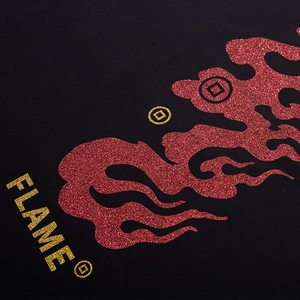 Close-up of oversized black street style T-shirt with red flames and glitter FLAME print
