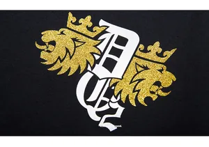 Detail of golden glitter lion crest print on black oversized streetwear sweatshirt