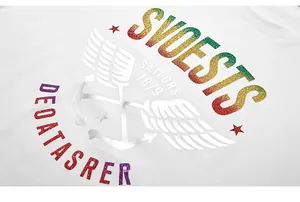 Close-up of rainbow glitter wing and anchor print on white cotton T-shirt