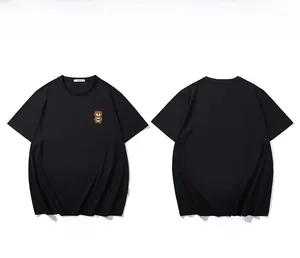 Flat lay view of a black oversized cotton t-shirt featuring a cartoon bear chest print