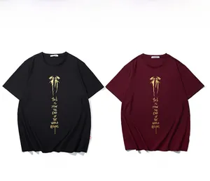 Flat lay of black and burgundy oversized T-shirts with gold foil lettering on white background