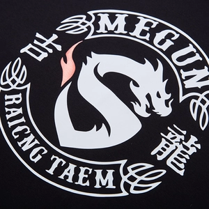Close-up of black oversized T-shirt featuring dragon S logo and circular graphic print