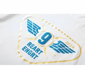 Close-up of white cotton T-shirt featuring blue glitter wing print and golden outlines