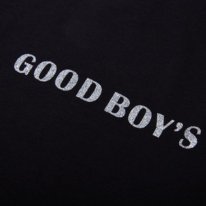 Close-up of black oversized T-shirt with sparkling silver glitter GOOD BOY'S lettering