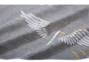 Close-up of gray cotton fabric texture with white letters and yellow crown print