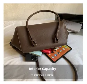 Spacious interior of dark brown pebbled leather bowling bag with daily essentials