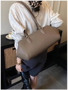 Litchi texture leather Boston bag shown in a lifestyle scene for daily commuting
