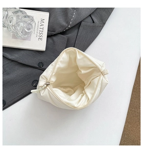 Spacious interior of ivory quilted cloud makeup bag with zipper and soft fabric lining