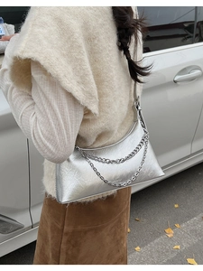 Close-up of metallic silver pleated shoulder bag featuring a double layered chain detail