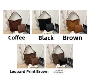 Detailed view of bucket bag set in coffee, black, brown, and leopard print finishes