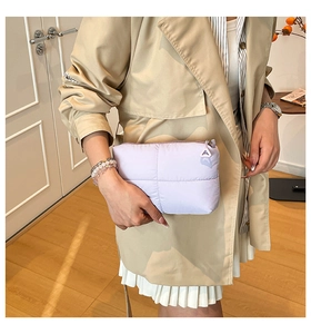 Detail of light purple quilted padded clutch bag with triangle zipper puller