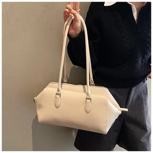 Detail of minimalist cream leather tote bag with grainy texture and long handles