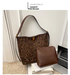 Detail of leopard print tote bag and brown inner pouch with metal lock in lifestyle setting