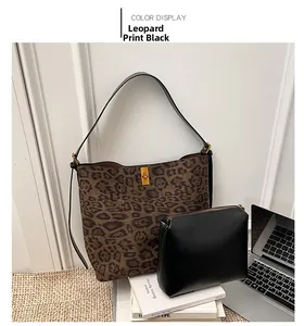 Leopard print bucket bag with black pouch and golden twist lock on a minimalist rug