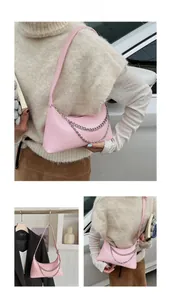 Pale pink leather crescent bag with silver chain detail shown in multi-angle model views
