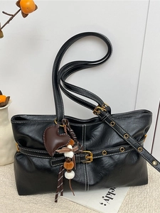 Retro black leather tote bag with white contrast stitching and heart charm accessory