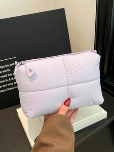 Quilted lavender cloud clutch bag with puffy nylon texture and resin zipper detail