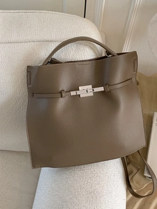 Brown litchi grain leather bucket bag with silver twist lock and adjustable shoulder strap