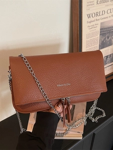 Brown litchi leather flap handbag with silver chain strap and Maven & Chic logo
