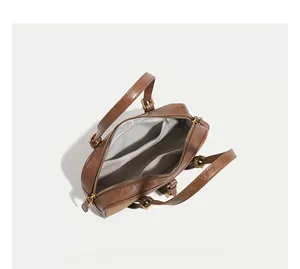 Top view of brown Boston bag interior with gray lining and spacious dual pocket layout