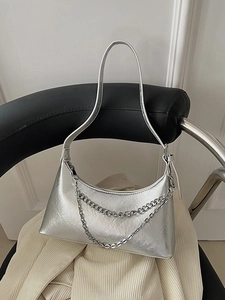 Silver metallic pleated handbag with double chain detail for women shown in a lifestyle view