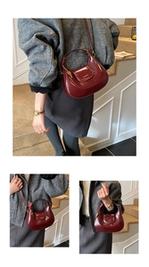 Close-up of burgundy patent leather crescent bag with gold buckle and woven strap details