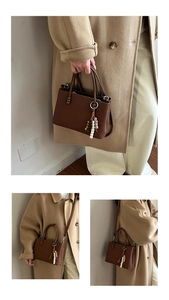 Detail of dark brown pleated tote bag with bead charm and detachable shoulder strap
