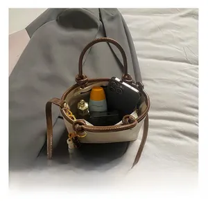 Top view of two-tone bucket bag interior showing capacity for phone and cosmetics