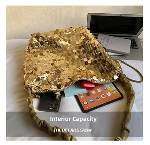 Detailed interior of a gold sequined shoulder bag showing spacious storage capacity